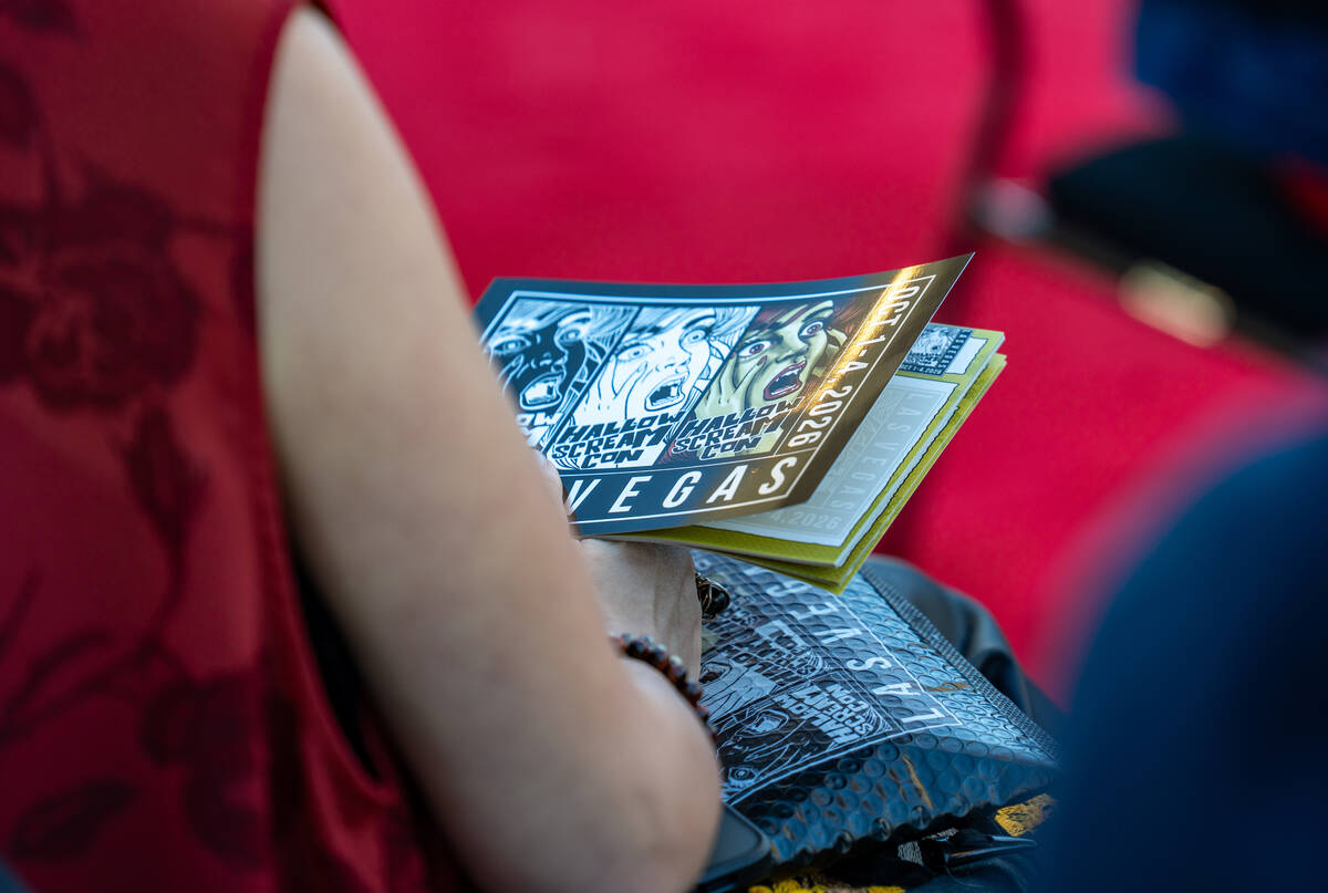 Guests flip through information books during an event announcing HallowScreamCon and HallowScre ...