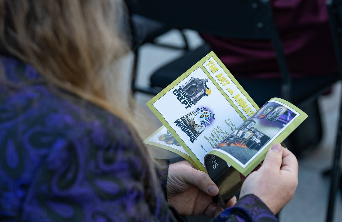 Guests flip through information books during an event announcing HallowScreamCon and HallowScre ...