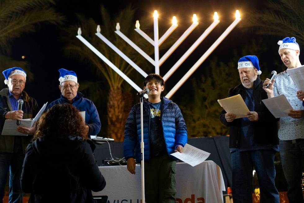 The Intergenerational Choir performs during the fourth night of Hanukkah celebration with Jewis ...