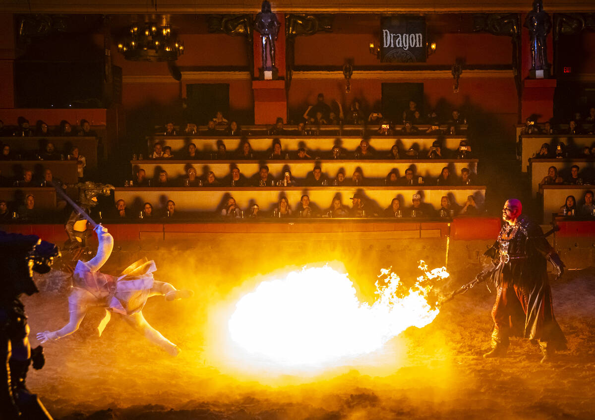 Mordred (Timothy Burris) shoots flames, sending Prince Christopher (Carter Maczan) flying, duri ...