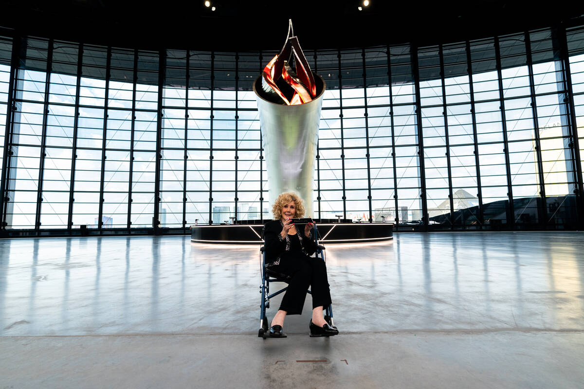 Carol Davis, wife of former Raiders coach, general manager and owner Al Davis, signs a plaque f ...