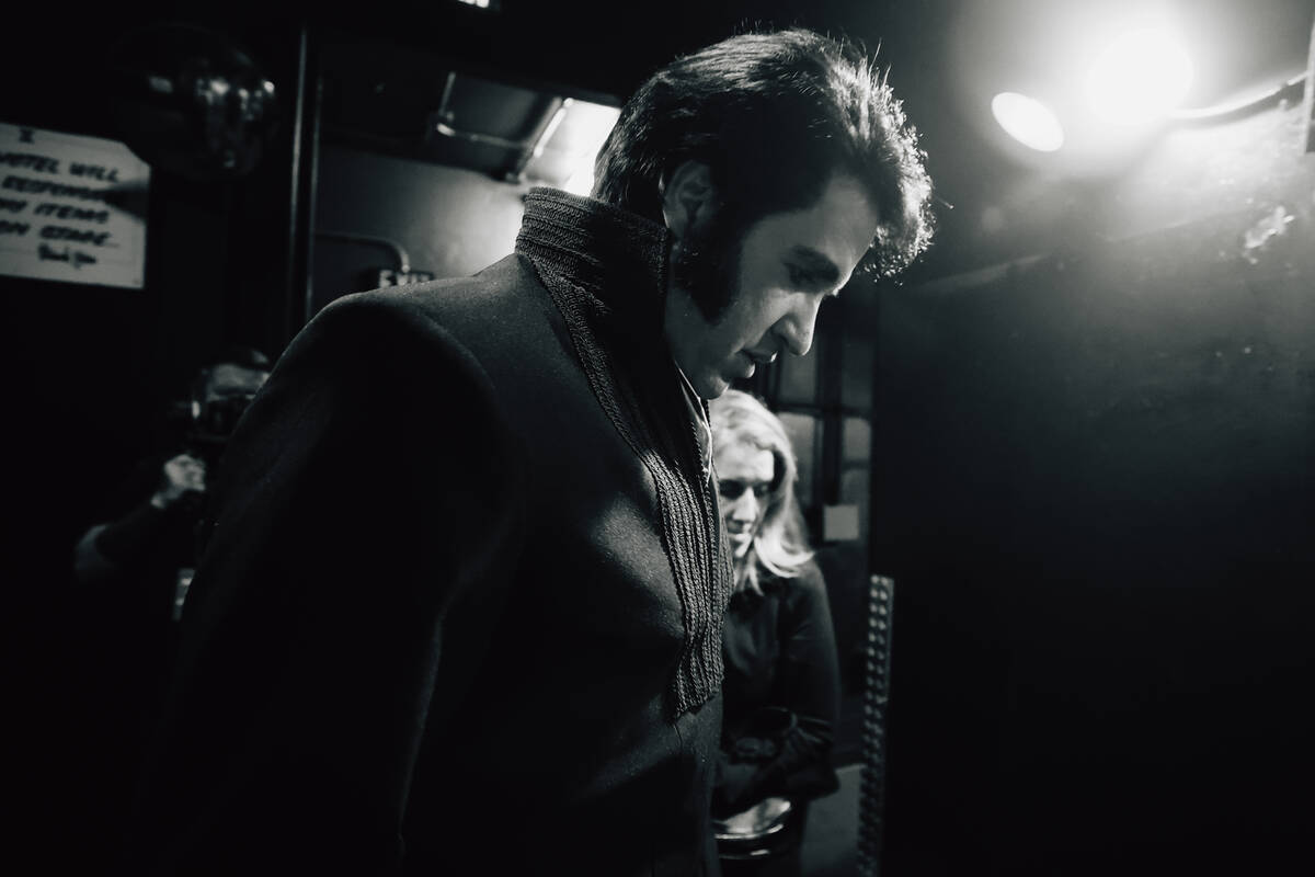 Travis Powell, an Elvis tribute artist, walks to the prayer wall before performing in “1 ...