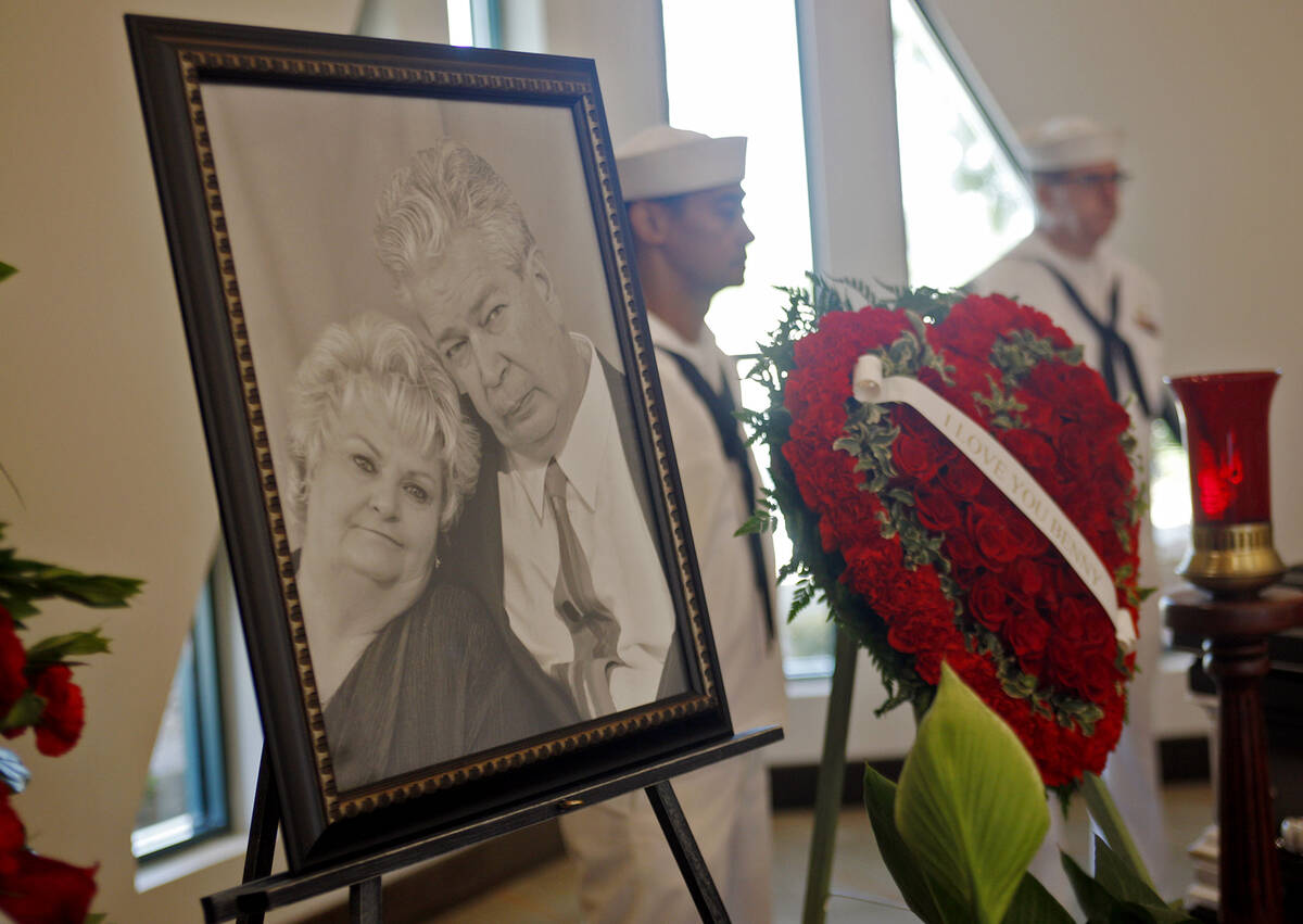 A photo of Richard "The Old Man" Harrison and his wife JoAnne Rhue Harrison near his casket at ...