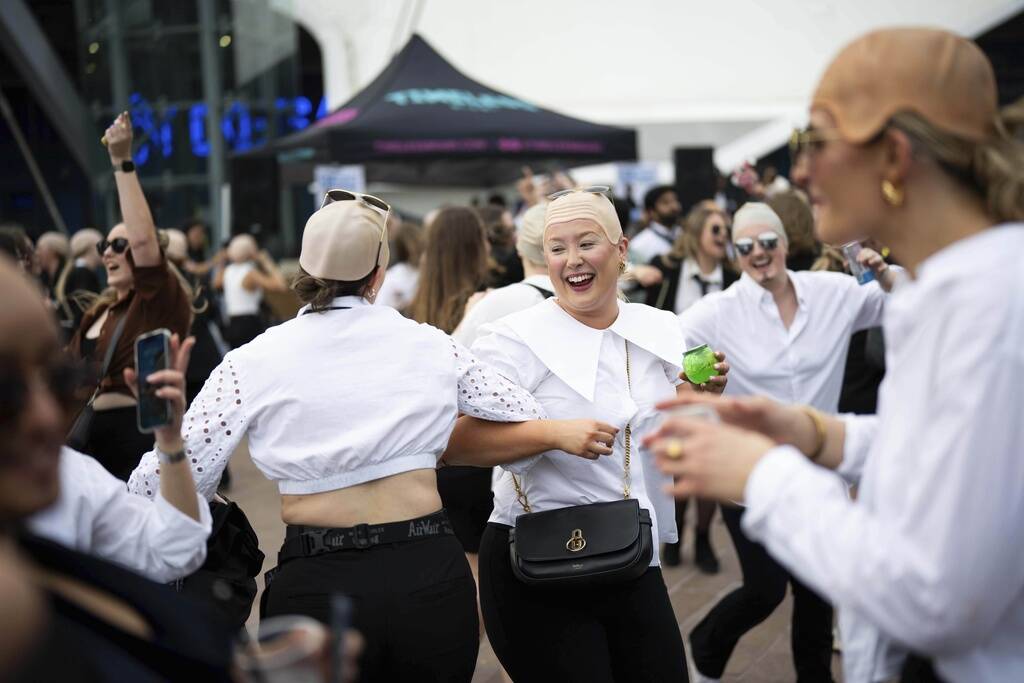 Fans dance in front of the O2 Arena prior to a performance by Pitbull on Monday, June 9, 2025, ...