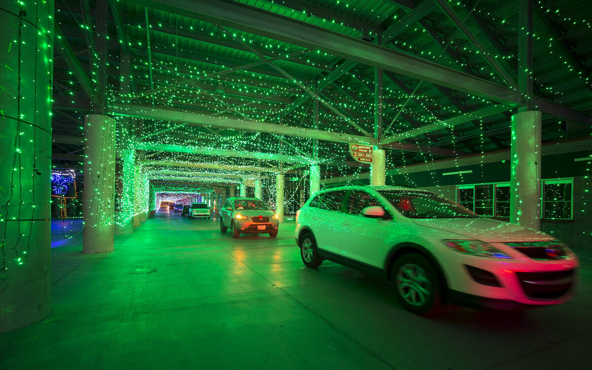 Vehicles travel through the Glittering Lights show at the Las Vegas Motor Speedway in Las Vegas ...