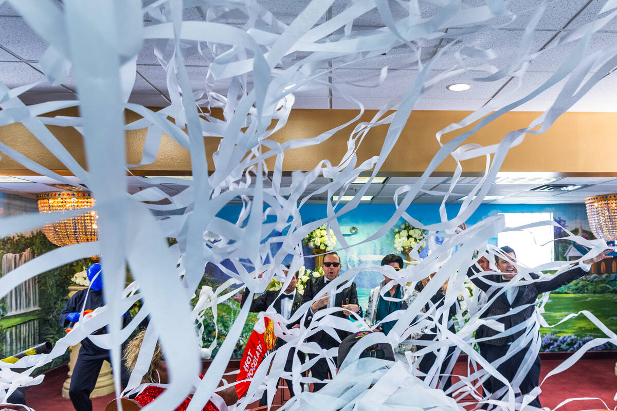 Members of the Blue Man Group deploy paper streams at the New Kids on the Block and Elvis as th ...