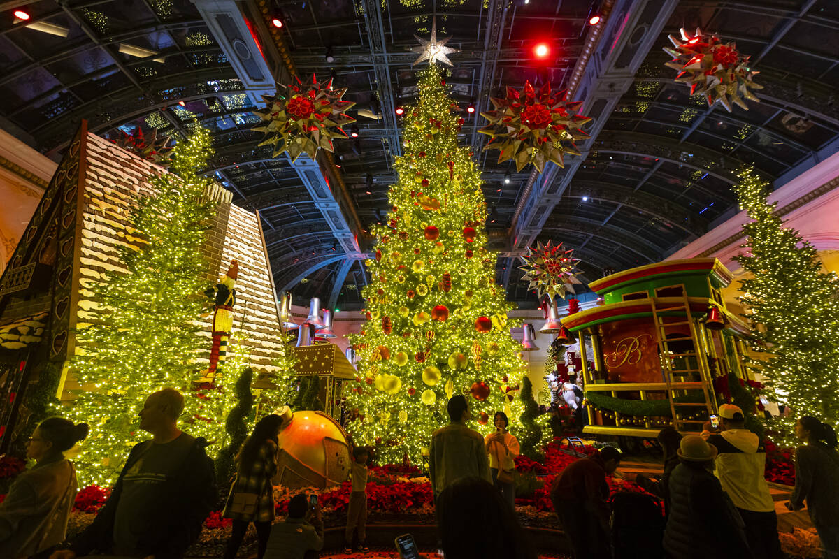 People explore the holiday display at the Bellagio Conservatory & Botanical Gardens on Sund ...