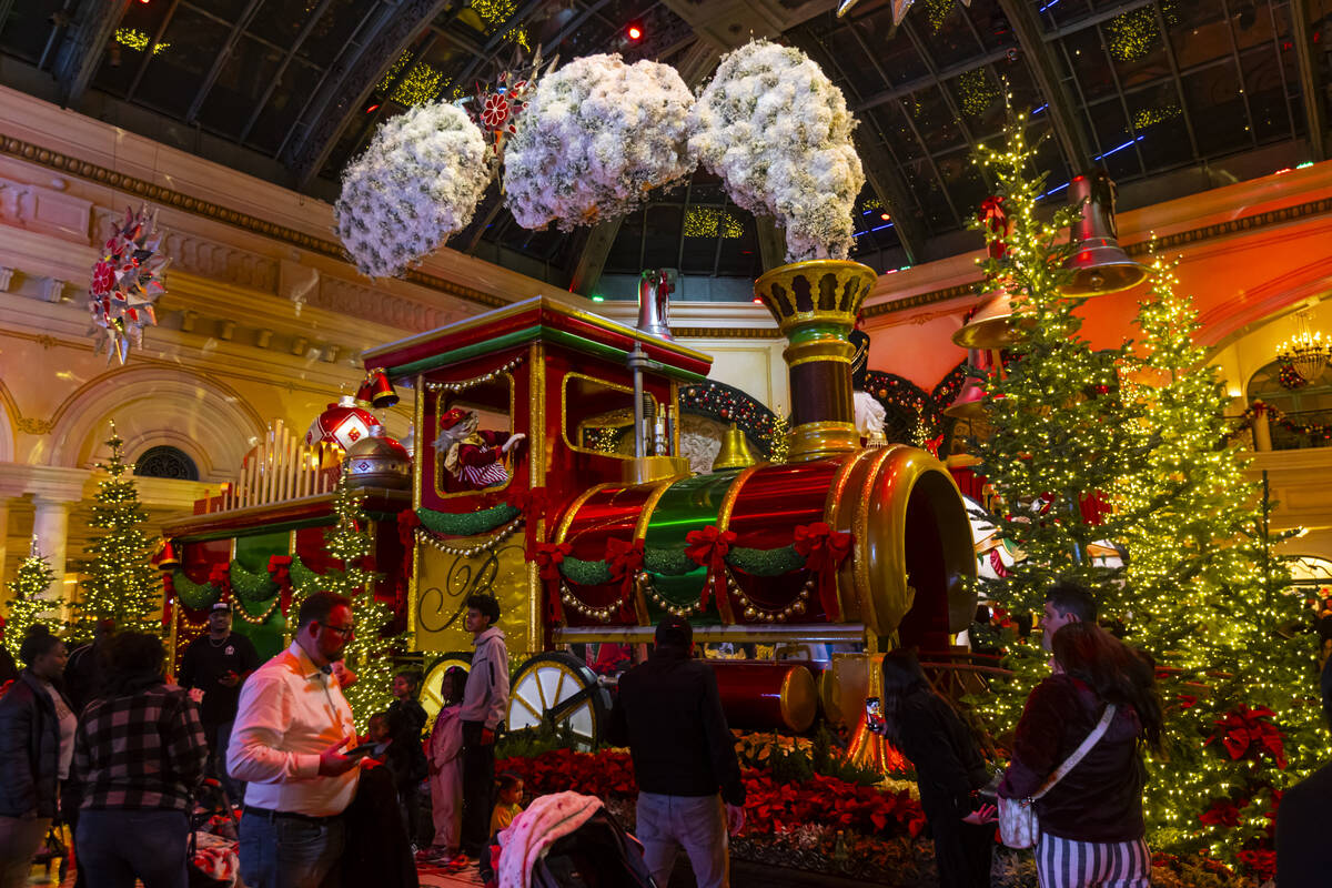 People explore the holiday display at the Bellagio Conservatory & Botanical Gardens on Sund ...