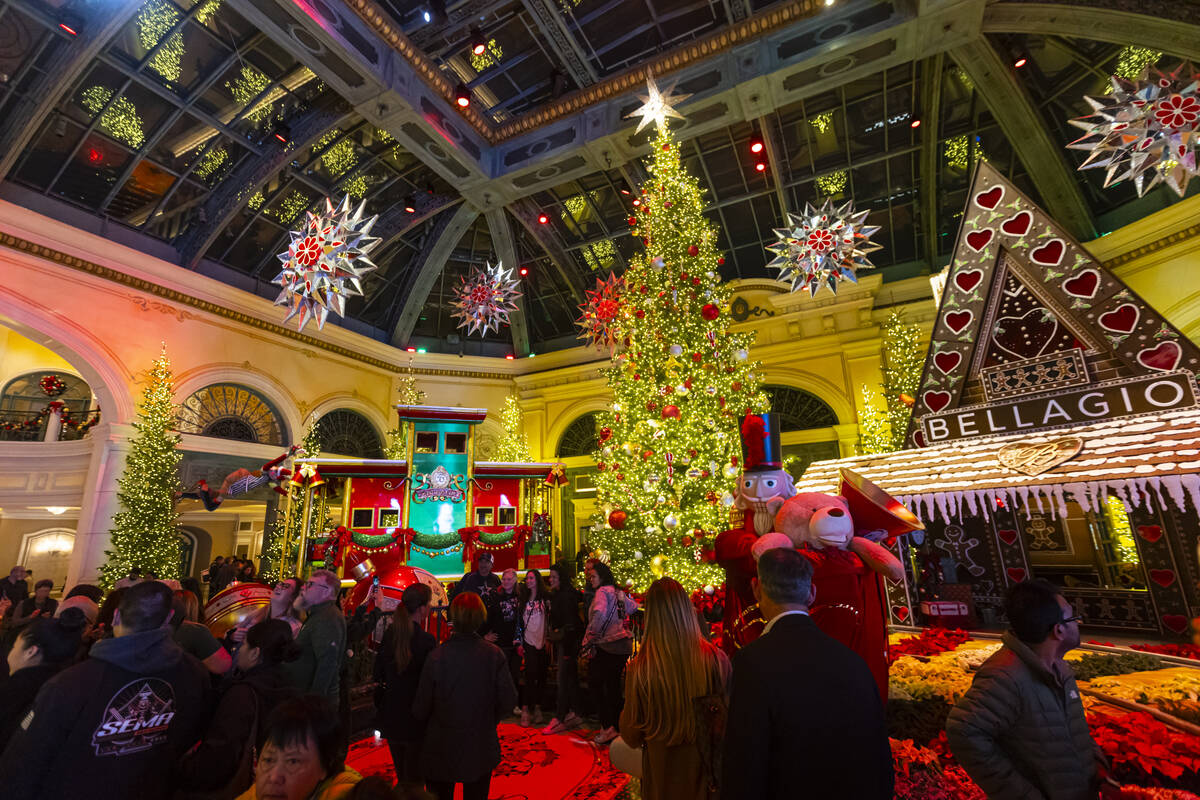People explore the holiday display at the Bellagio Conservatory & Botanical Gardens on Sund ...