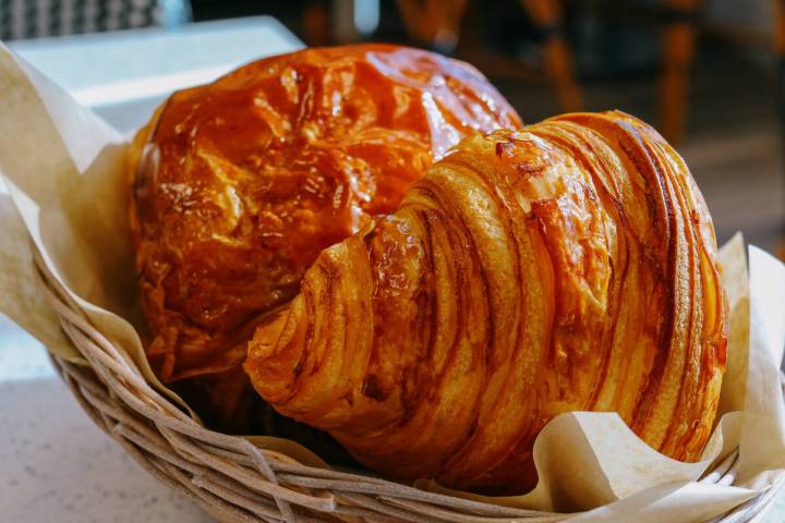 A croissant, front, and pain au chocolat are seen at Cafe Breizhh on Wednesday, June 18, 2025, ...