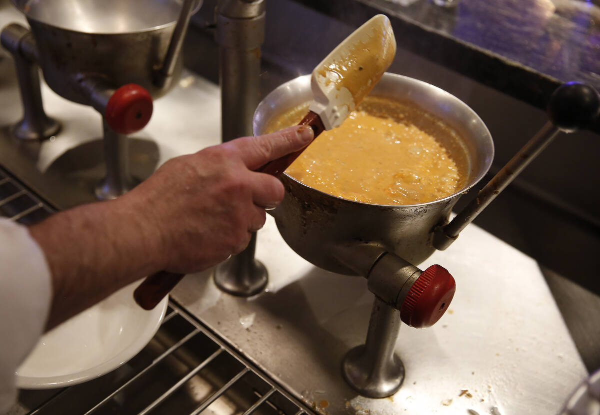 Chef Evan Morris monitors food cooking at Oyster Bar at Palace Station hotel-casino on Saturday ...