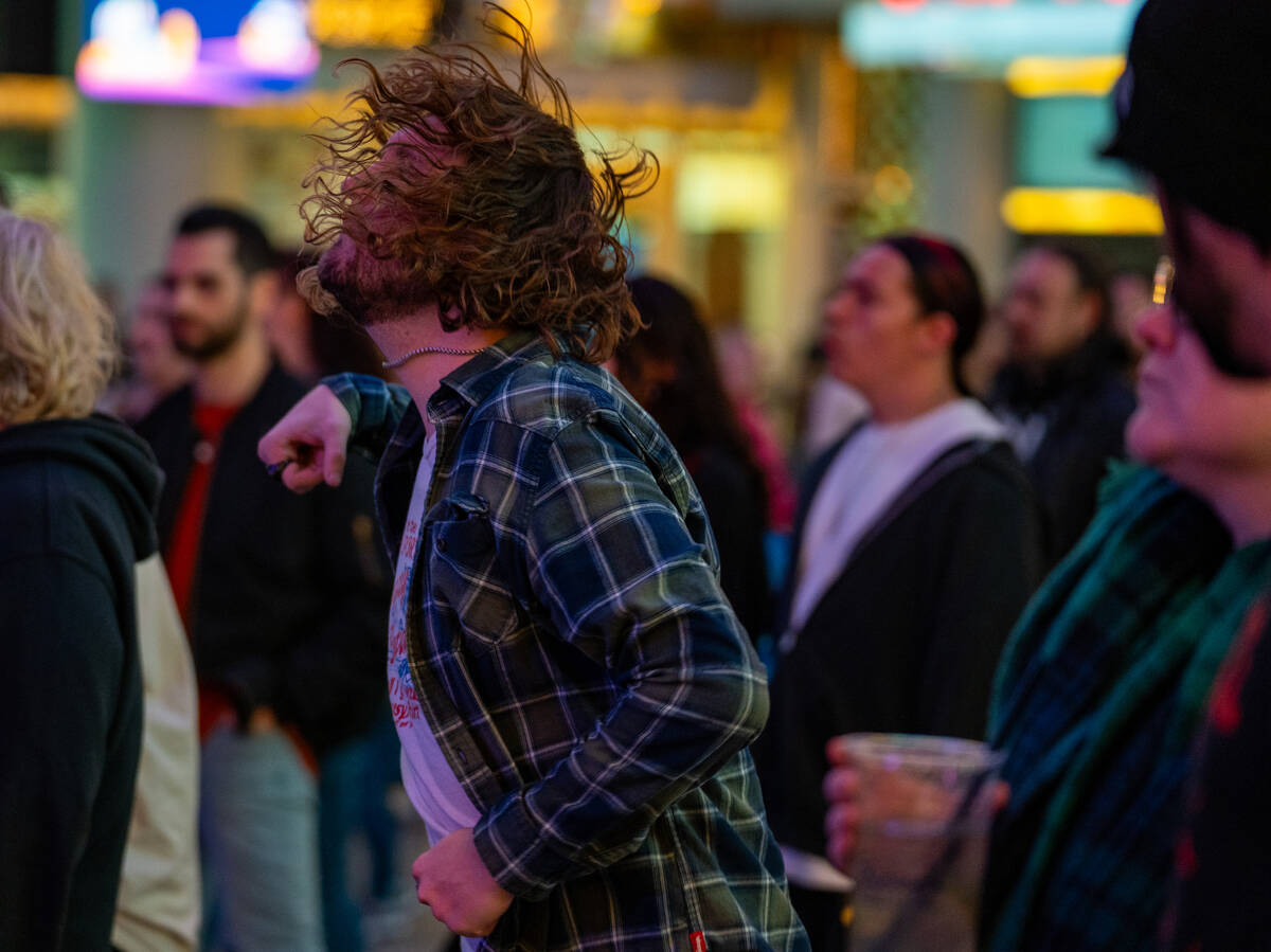 Fans dance as Pure Sport preforms on the First Street stage during the Neon City Music Festival ...