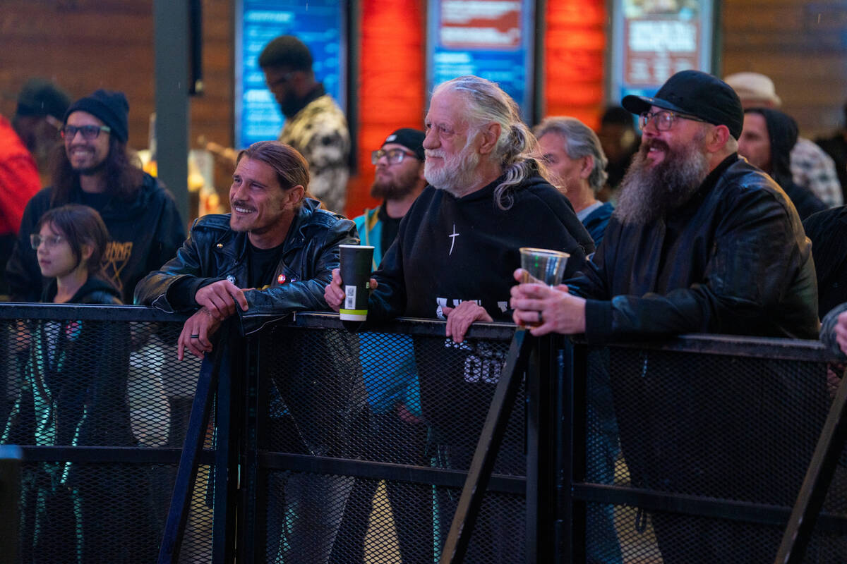 Fans listen as The Dollheads preform on the Main Street stage during the Neon City Music Festiv ...