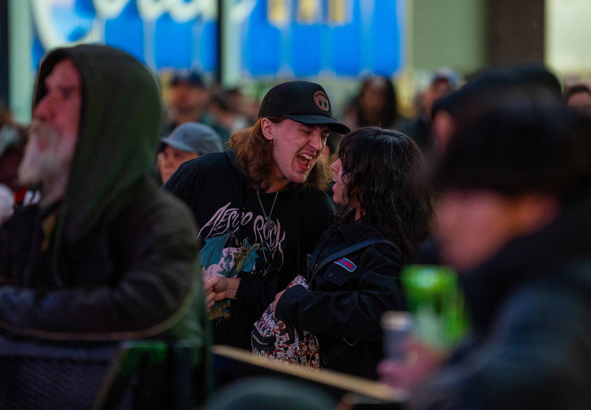 Fans sing along as The Dollheads preform on the Main Street stage during the Neon City Music Fe ...