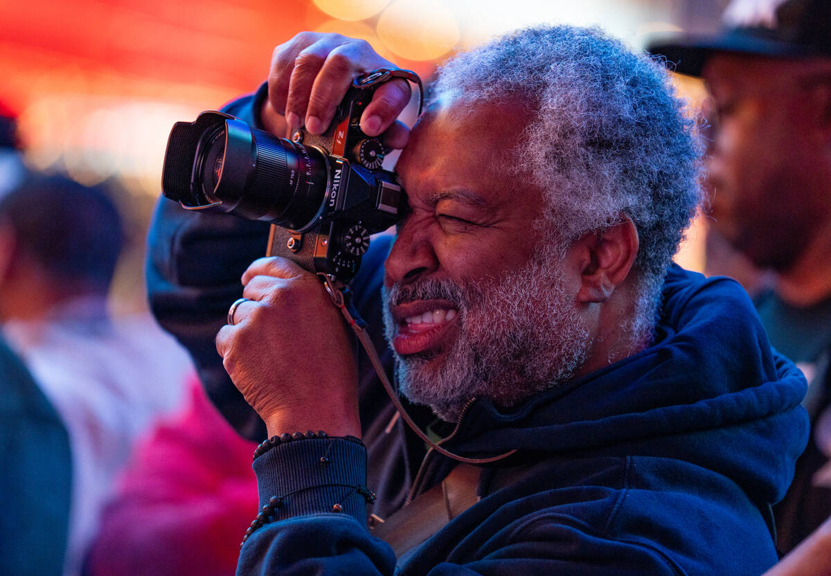 A fan snaps a picture while De La Soul preforms on the Third Street stage during the Neon City ...