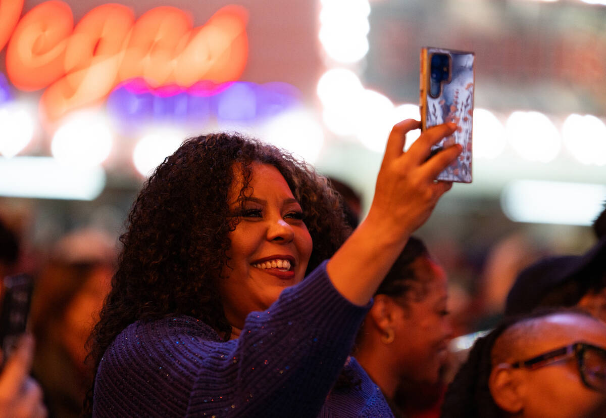 A fan records as De La Soul preforms on the Third Street stage during the Neon City Music Festi ...