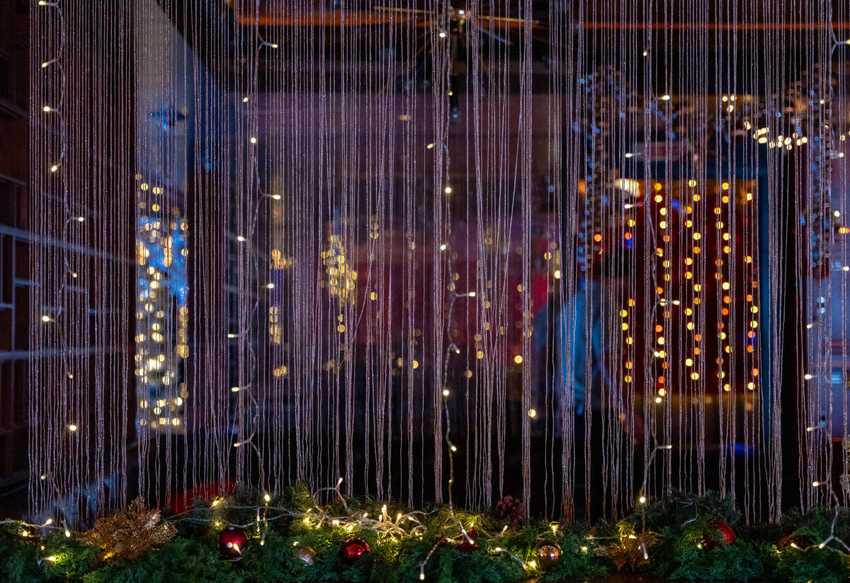 Many types of lights and sparkly garland decorate the inside of The Mariah Carey Holiday Bar po ...