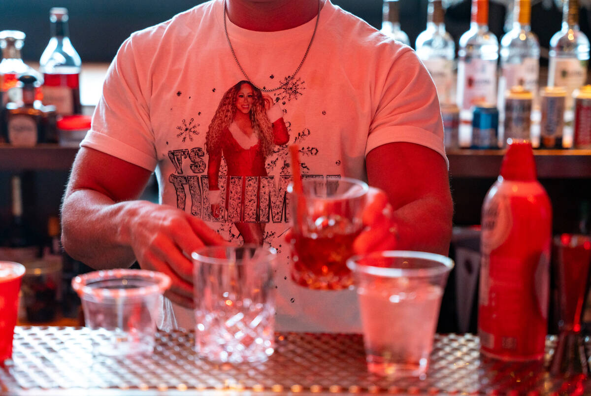 Bartender Peter Picciano II makes a signature drink at The Mariah Carey Holiday Bar pop-up insi ...