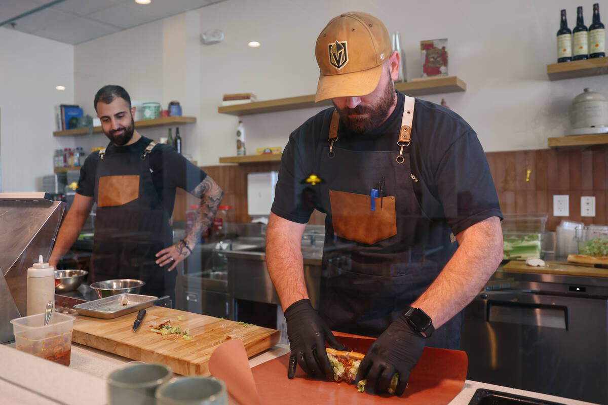 Ramtin Yashar and Scott Arn make sandwiches at Golden Boy Market & Deli on Tuesday, July 15, 20 ...
