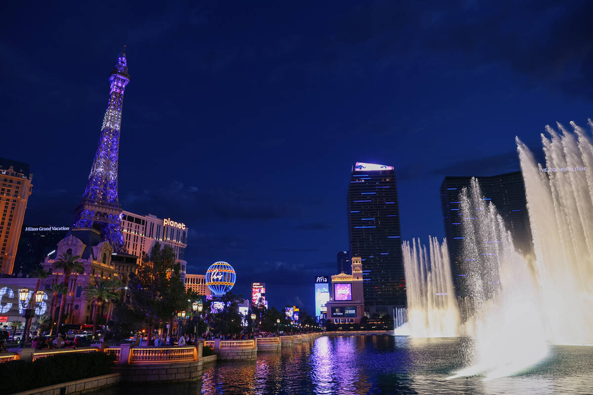 Tourists watch the fountains go off to the tune of “Luck Be a Lady” by Frank Sina ...