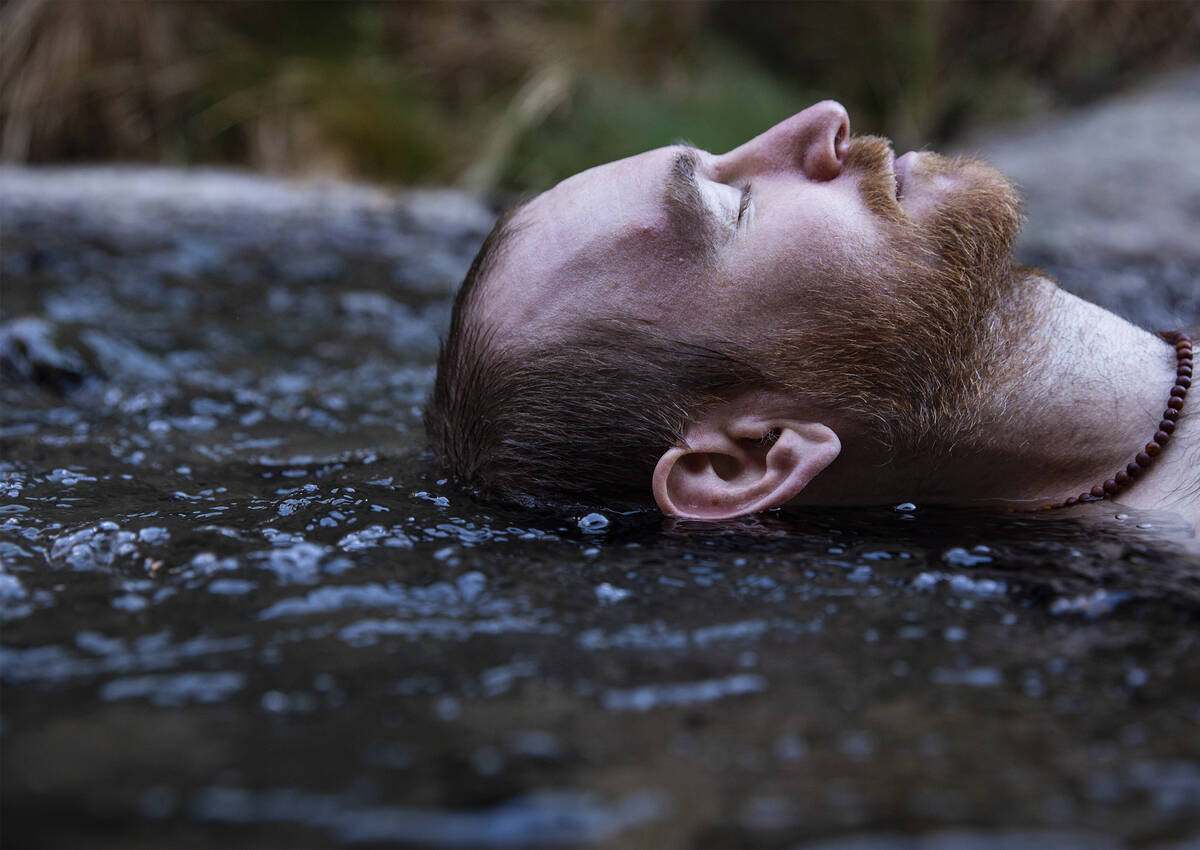 Andy Udelsman of Las Vegas lies in the warm waters from the Gold Strike Hot Springs along the C ...