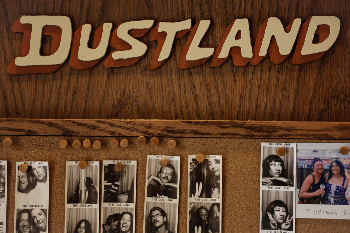 Posted photos from the photo booth are displayed at The Dustland Bar Friday, Sept. 26, 2025 in ...