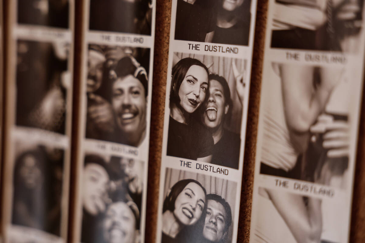 Posted photos from the photo booth are displayed at The Dustland Bar Friday, Sept. 26, 2025 in ...