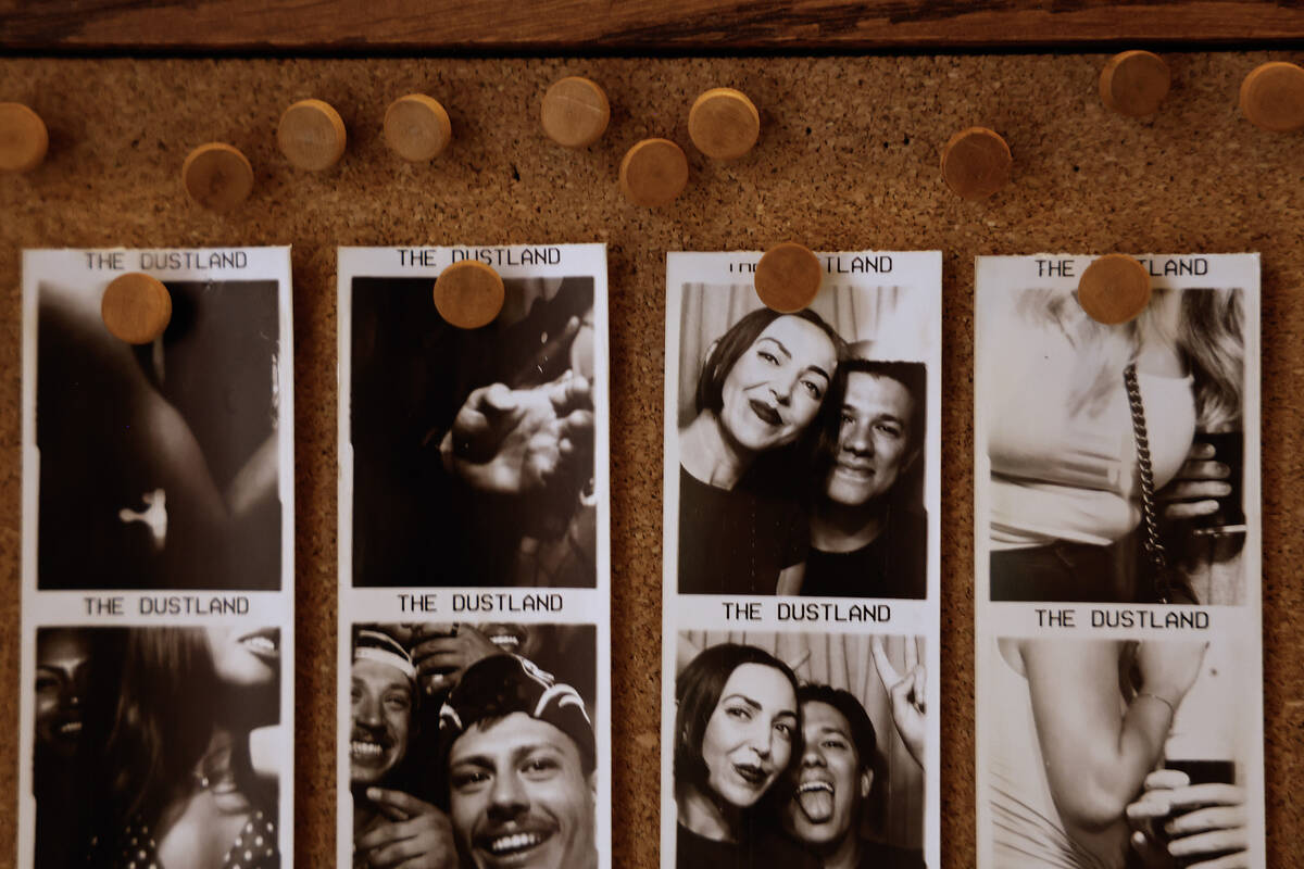 Posted photos from the photo booth are displayed at The Dustland Bar Friday, Sept. 26, 2025 in ...
