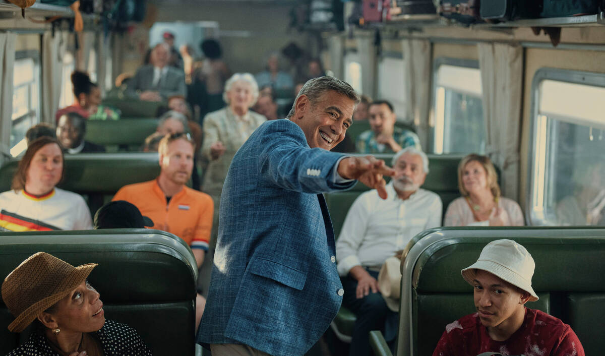 This image released by Netflix shows George Clooney, center, in a scene from "Jay Kelly." (Pete ...