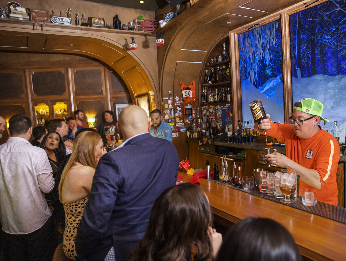 Mixologist Jason Hughes, right, makes drinks at Ski Lodge on Saturday, May 14, 2022, at The Cos ...