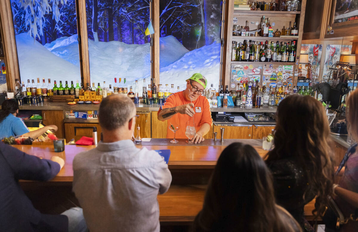 Mixologist Jason Hughes, right, makes drinks at Ski Lodge on Saturday, May 14, 2022, at The Cos ...