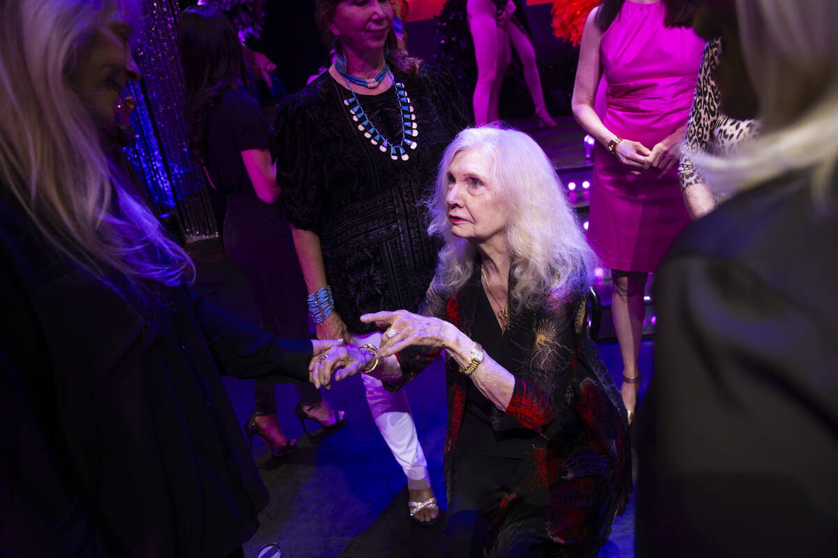 Retired showgirls, including Cindy Doumani, 92, center, mingles before celebrating the first e ...