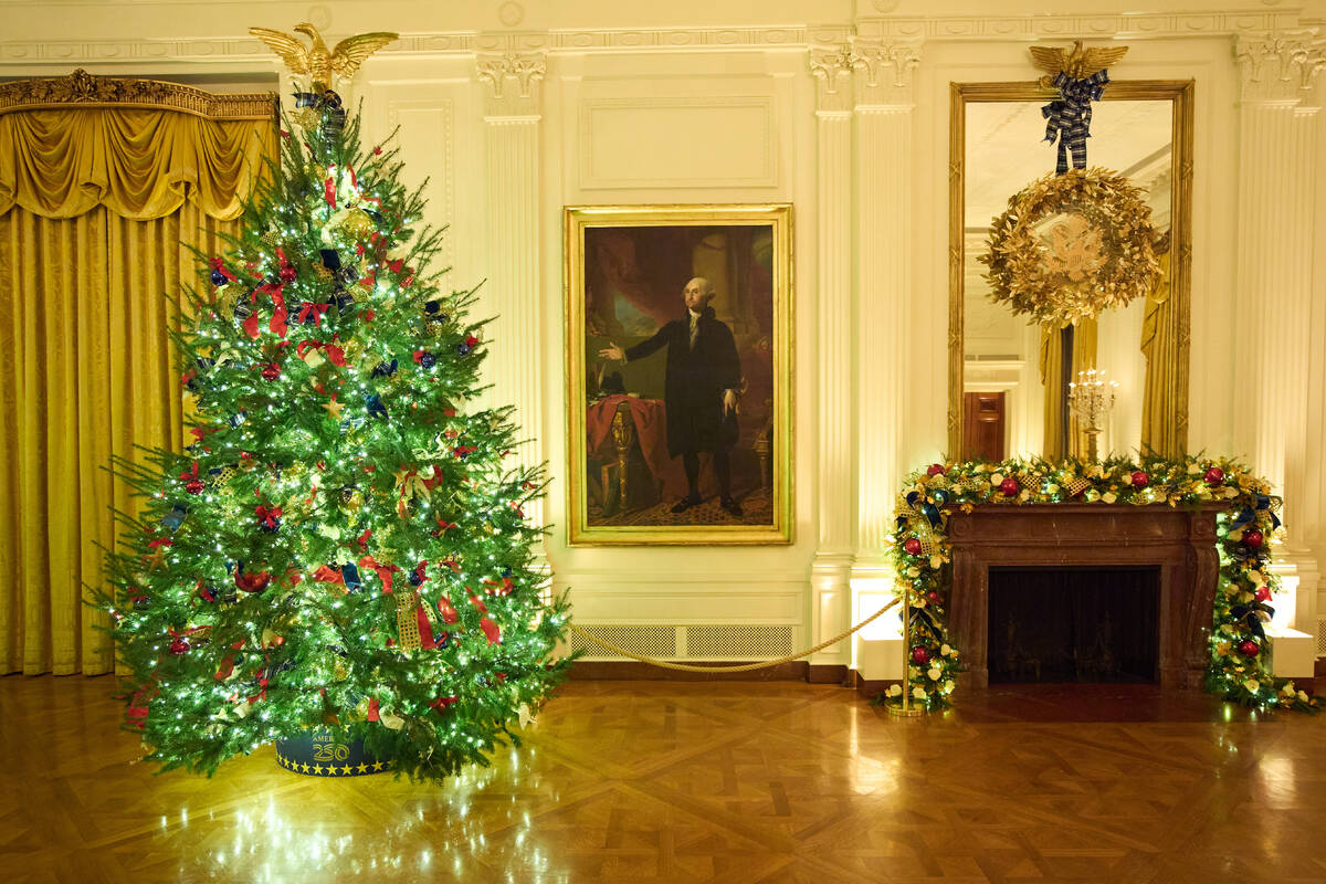 Christmas trees decorate the East Room of the White House during a press preview of the Christm ...