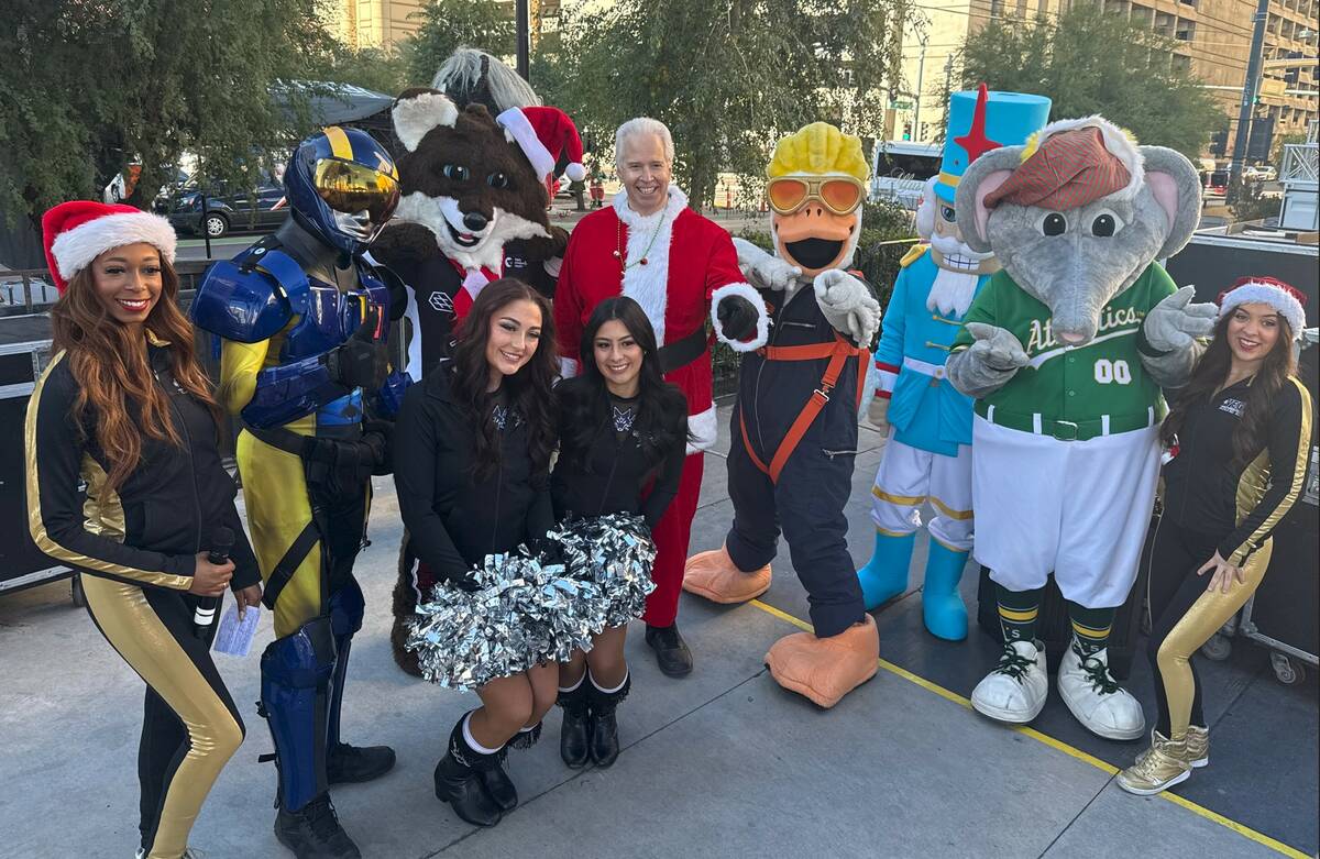 Opportunity Village CEO Bob Brown (center) is shown with a collection of Vegas pro-team mascots ...