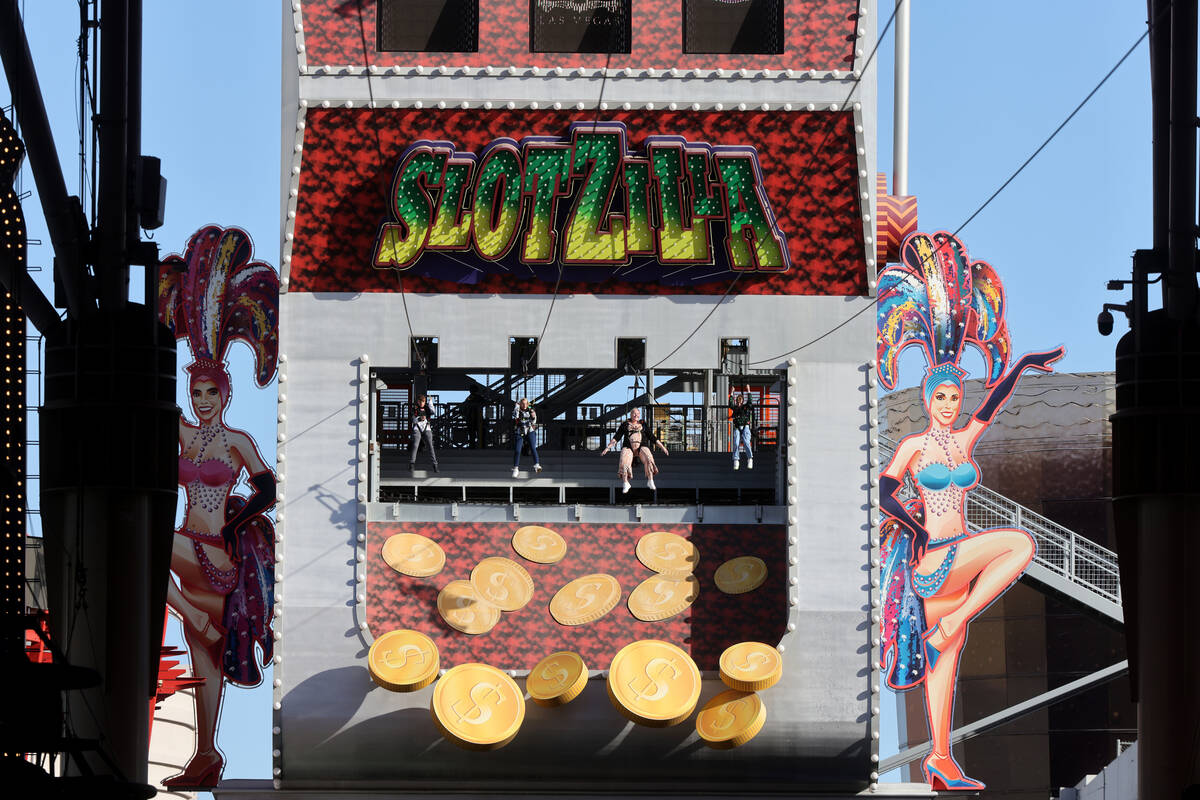 People ride the Zip-Zilla zip line on SlotZilla at the Fremont Street Experience in downtown La ...