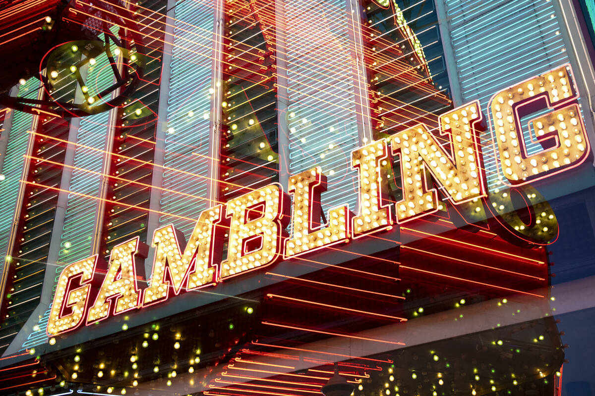 Different casino signs flash in a double exposure image at the Fremont Street Experience, Wedne ...