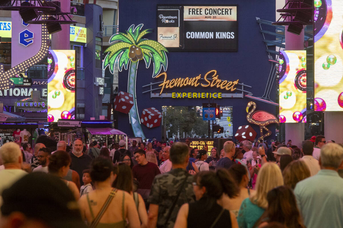 Groups of people walk up and down the Fremont Street Experience, Wednesday, Aug. 14, 2024, in L ...