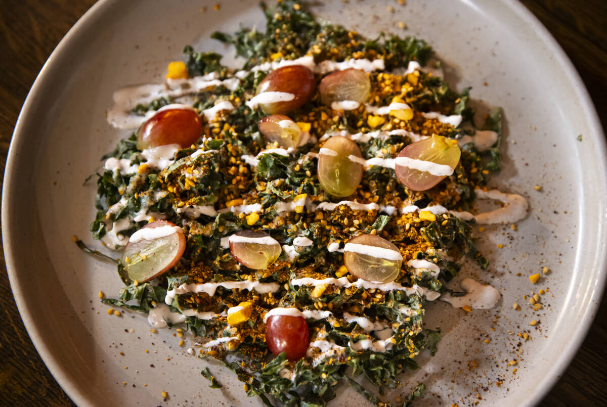 Kale salad with tahini, grapes, and almond dukkah is seen during a staff menu tasting at Ada&#x ...