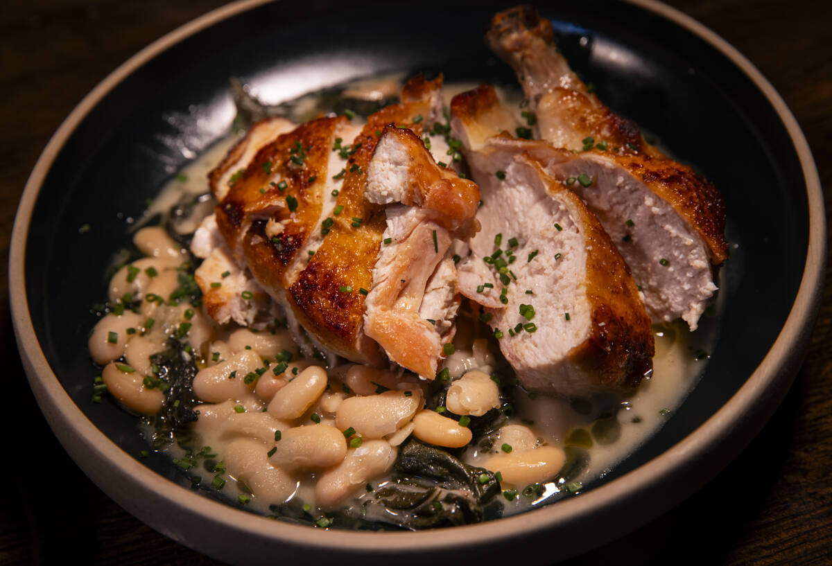 Mary’s chicken, with kale and white bean, is seen during a staff menu tasting at Ada ...