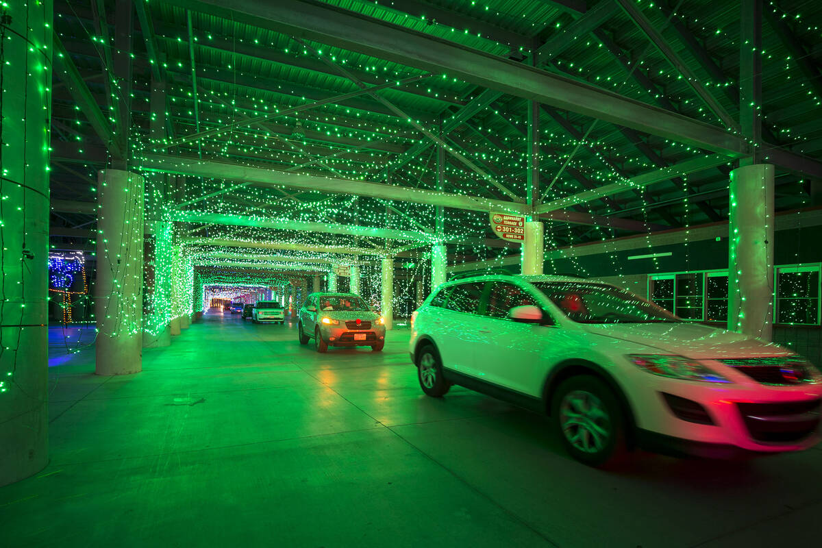 Vehicles travel through the Glittering Lights show at the Las Vegas Motor Speedway in Las Vegas ...