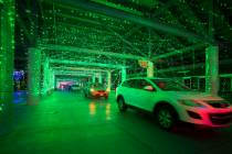 Vehicles travel through the Glittering Lights show at the Las Vegas Motor Speedway in Las Vegas ...