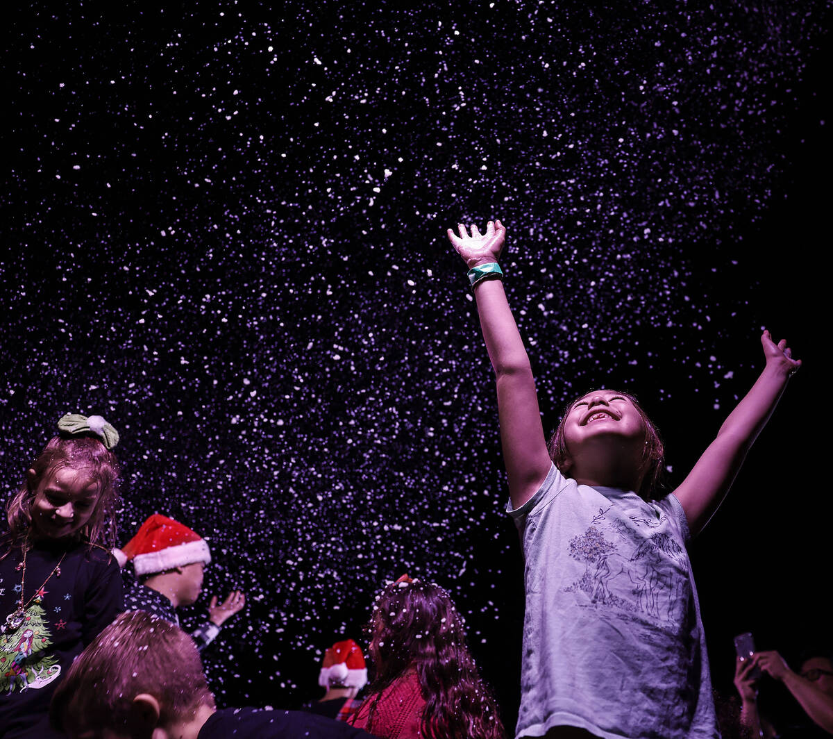 Lacey Wrightson, 7, plays in simulated snow during opening night of Ethel M's holiday cact ...