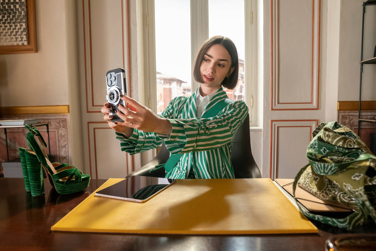 This image released by Netflix shows Lile Collins in a scene from "Emily In Paris." ( ...