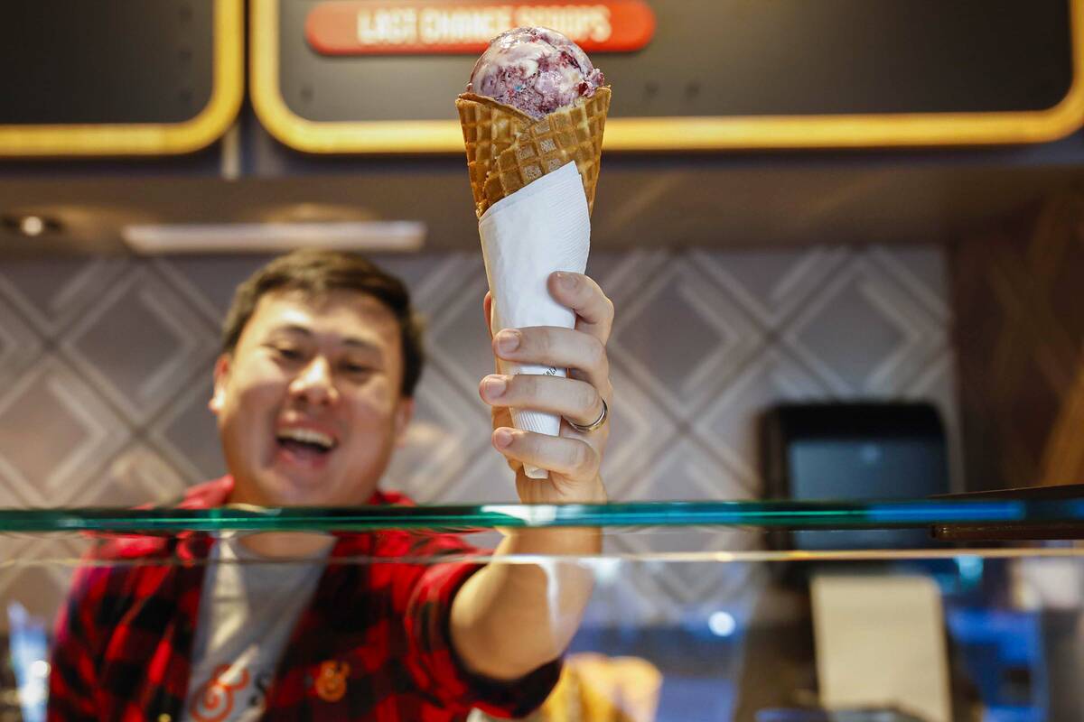 Chris Phu holds a sample cone of Pots of Gold and Rainbows two days before the opening of Salt ...