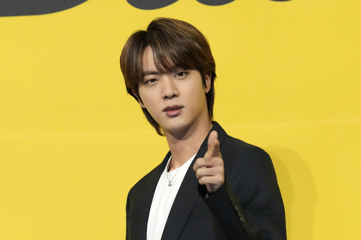 Jin, a member of South Korean K-pop band BTS, poses for photographers ahead of a press conferen ...