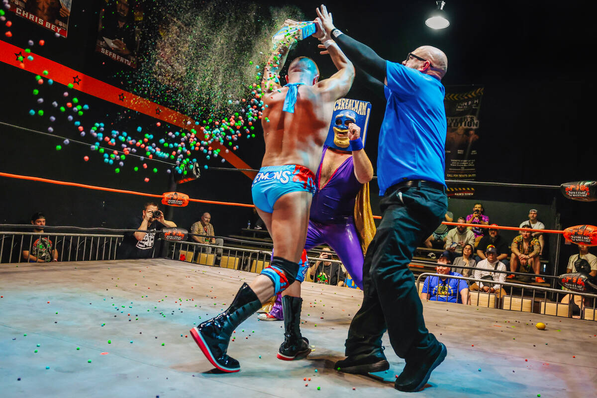 Cereal Man, middle, braces himself as competitor Manny Lemons, left, throws a box of cereal at ...