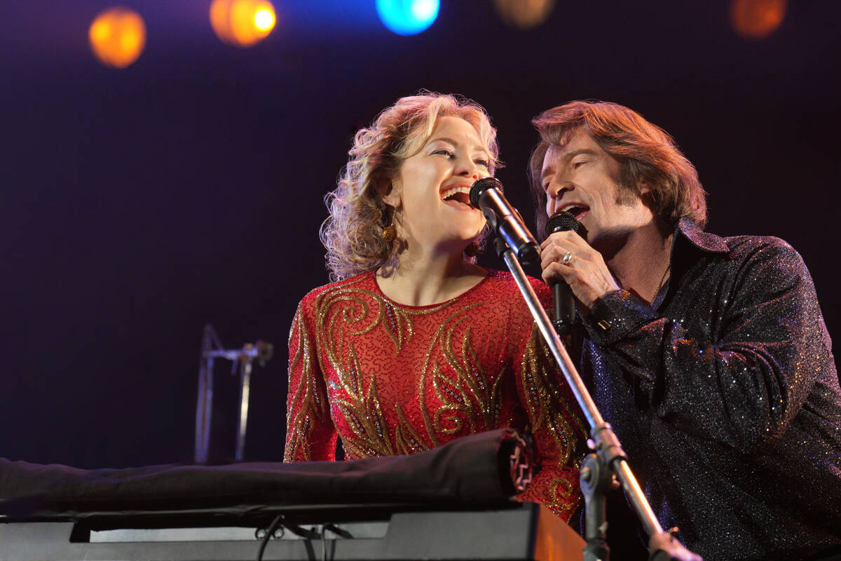 This image released by Focus Features shows Kate Hudson, left, and Hugh Jackman in a scene from ...