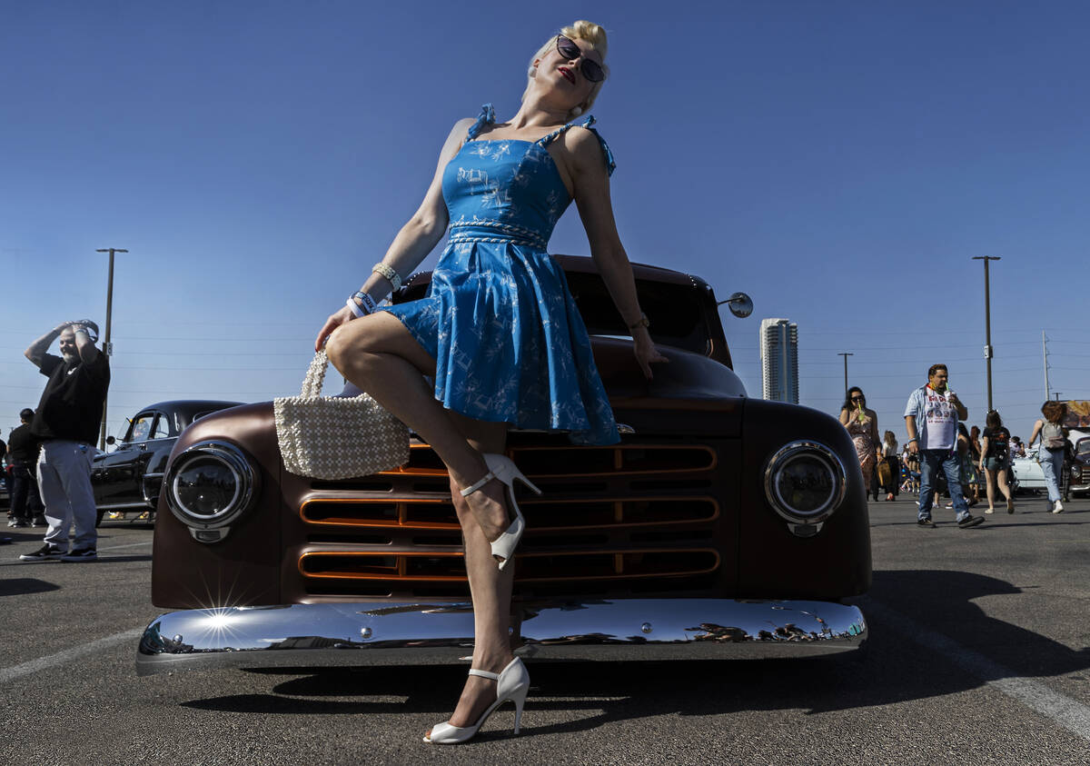 Miss Audrey Monroe, from Augusta, Ga., poses for photos in front of classic cars during the Roc ...