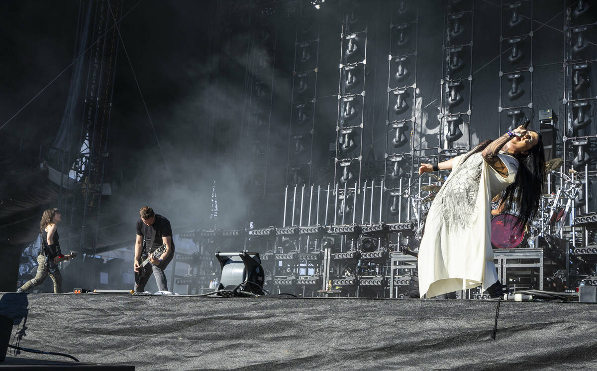 Evanescence lead singer Amy Lee, right, performs with the band during the Sick New World festiv ...