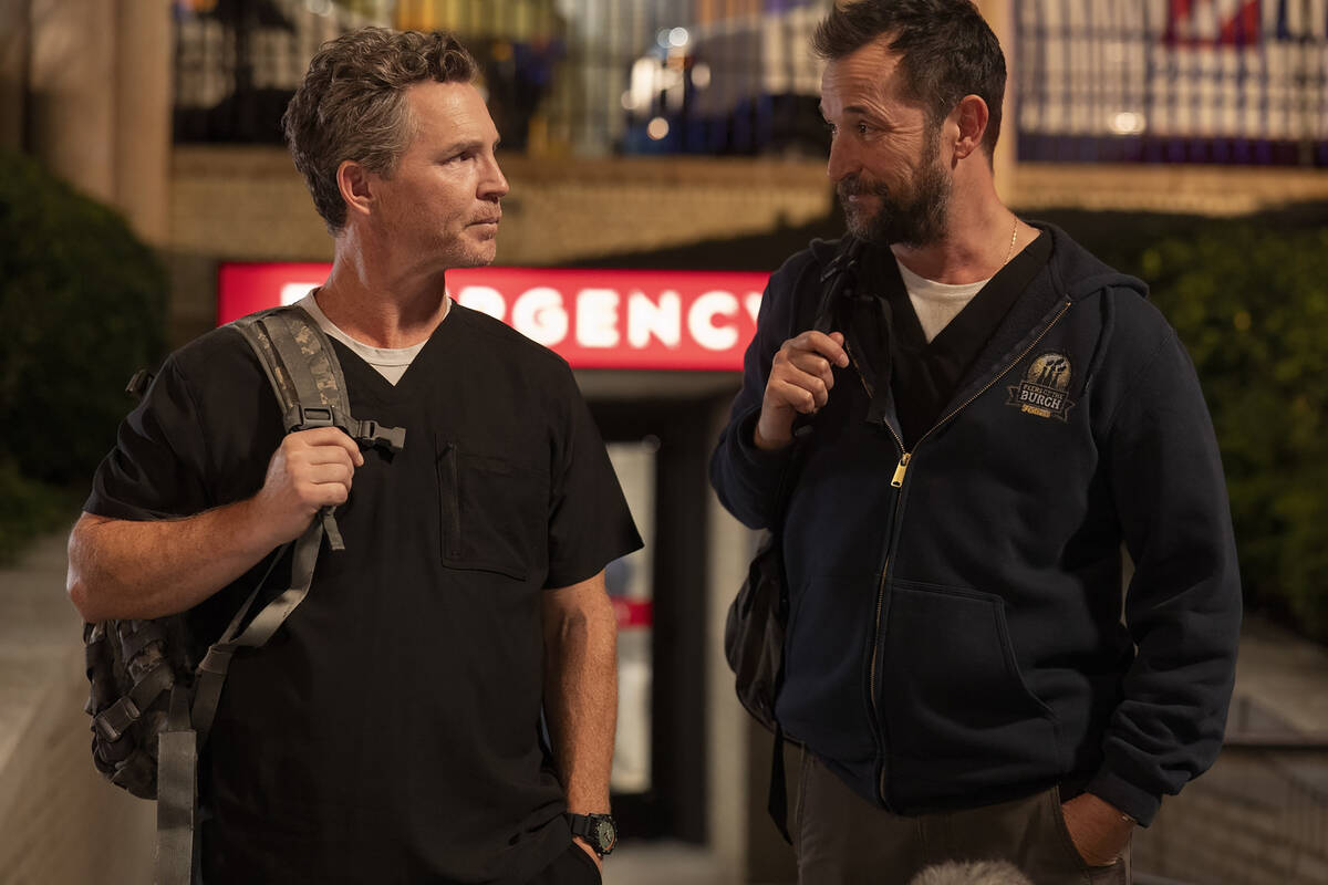 Robby (Noah Wyle), right, and Abbott (Shawn Hatosy) exit the hospital in a scene from "The ...